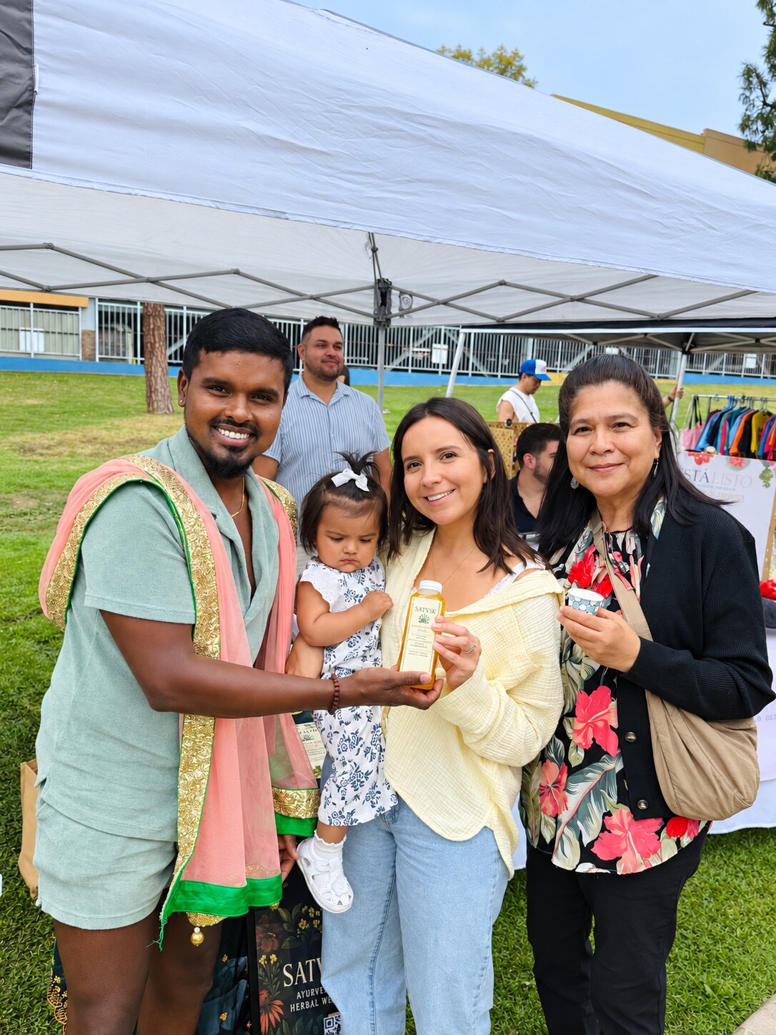 Friends gathering around Satvik at a community market