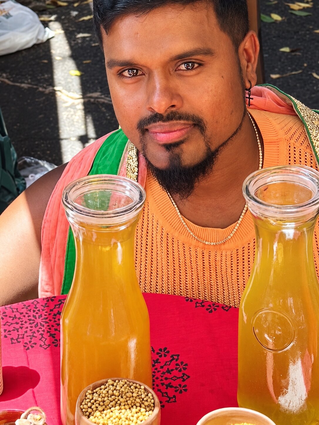 Satvik founder sharing herbal waters at an outdoor market