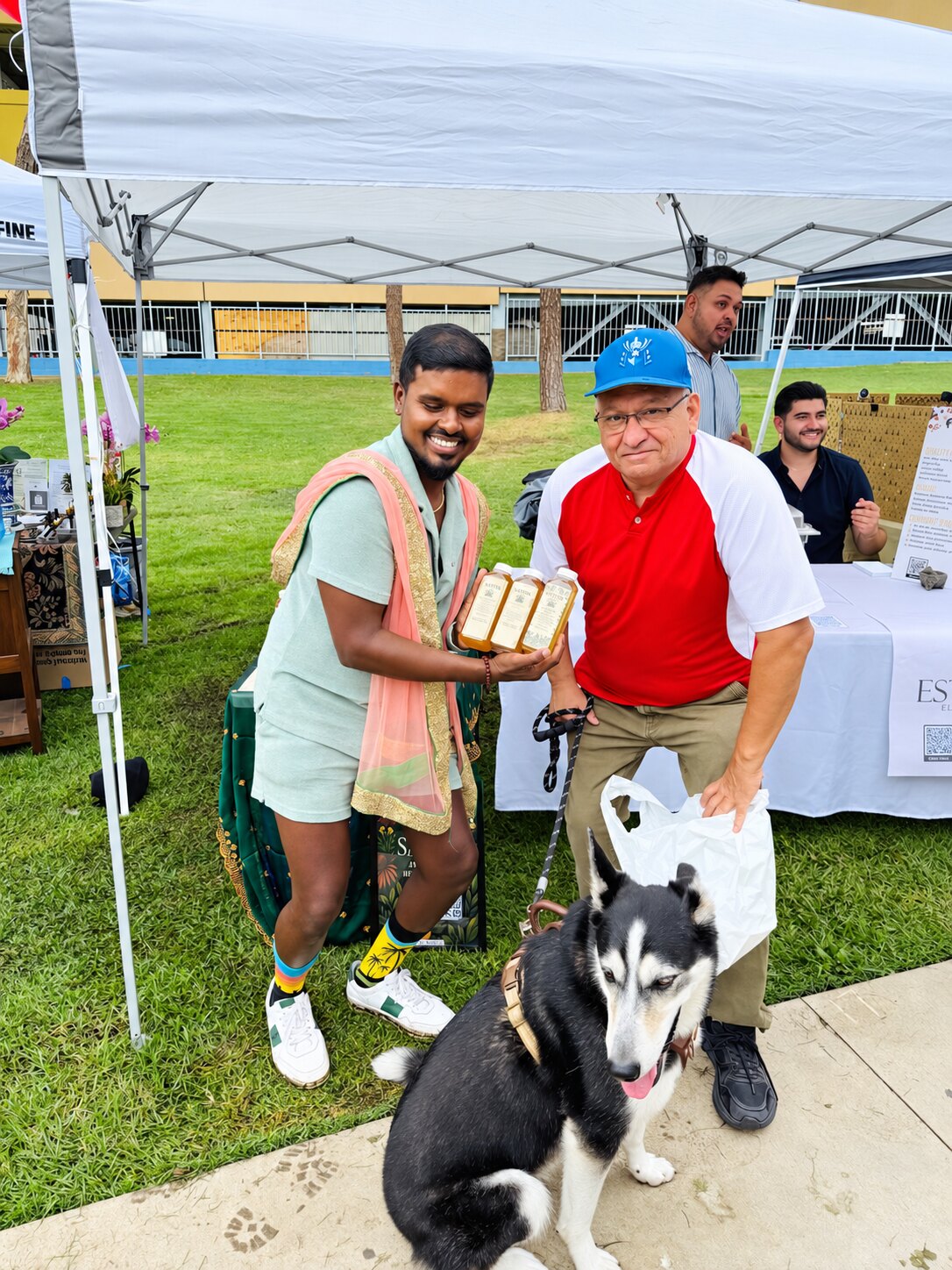 A guest and dog visiting the Satvik market booth